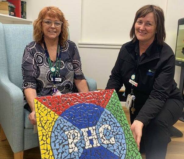 CREATIVEL Patricia Hinchey Centre volunteer Sherrie Hunt and manager Jacinta Harman with the piece that kicked off the project. Picture: TALLIS MILES