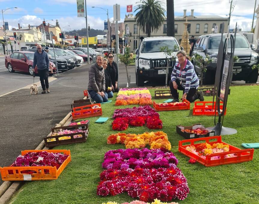 Leading Teacher of Ararat Primary School, Heidi Jerram, (centre) and helpers put the finishing touches to the floral words ANZAC. Each class of the Ararat Primary School made a letter for the display, Picture by Sheryl lowe