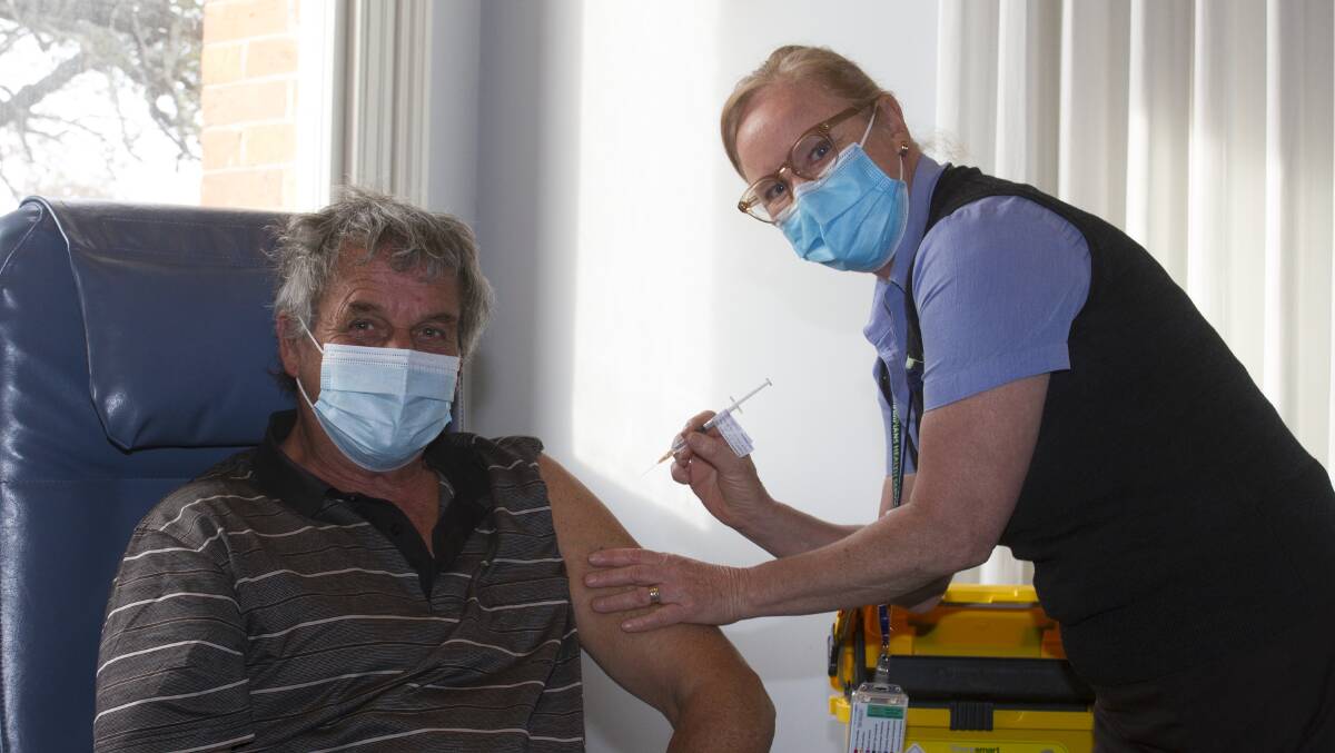 READY: Brenda Green administers the Astra Zenica vaccine to Peter Pickering. Picture: JEN PICKERING