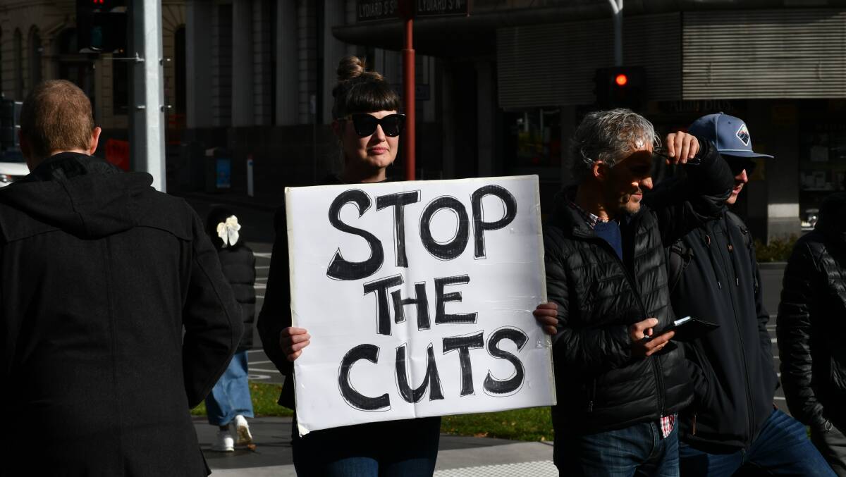 Demonstrator holding a 'stop the cuts' sign on Sturt Street, June 1. Picture by Alex Dalziel