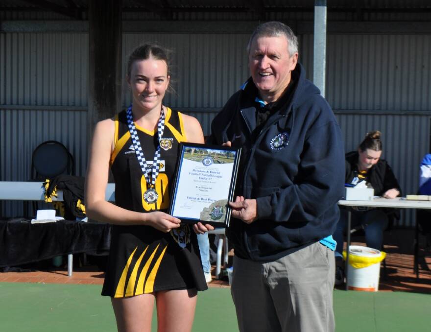 Pimpinio's Ava Fitzgerald receives her Blue Ribbon Foundation Spirit of Netball award from foundation member Les Power. Picture supplied