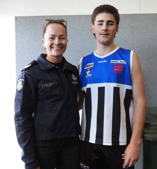 Minyip Murtoa's Jonathon Baker received his Blue Ribbon Foundation Spirit of Football award from Horsham police officer Angie Clark. Picture supplied