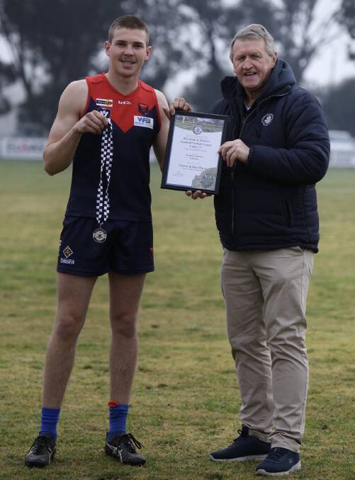 Archer Cameron receives his Blue Ribbon Foundation Spirit of Football award from foundation member Les Power. Picture supplied 