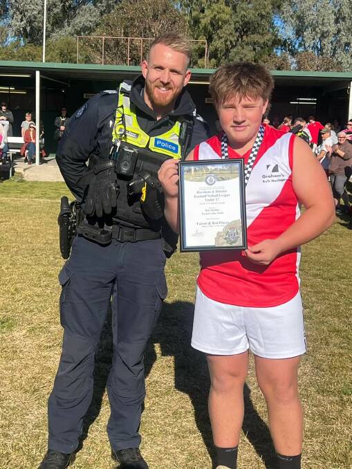 Taylors Lake's Ben Sladdin receives his Blue Ribbon foundation Spirit of Football award from Horsham police officer Acting Sergeant Marc Davey. Picture supplied