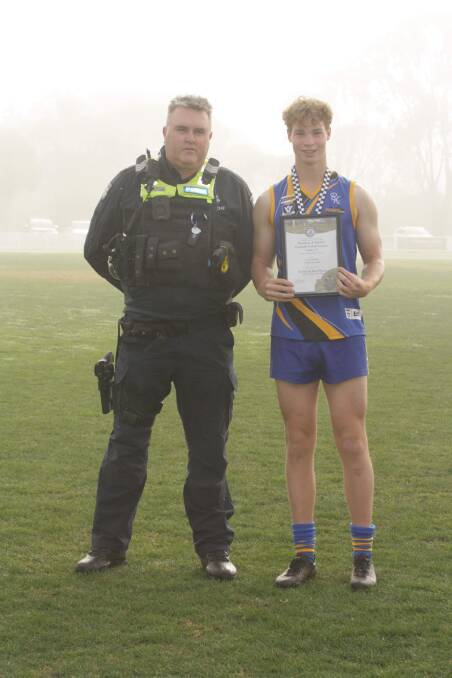 Natimuk United's Cody Keddie receives his Blue Ribbon Foundation Spirit of Football award from Horsham police officer Jason Bergen. Picture supplied