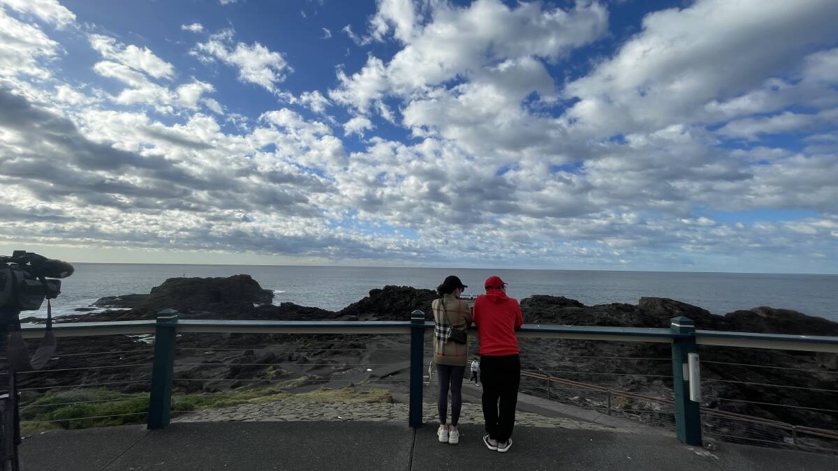Michael Bui's family - Vicky Nguyen and Tan Tran - at Kiama blowhole waiting for news. Picture by Sylvia Liber
